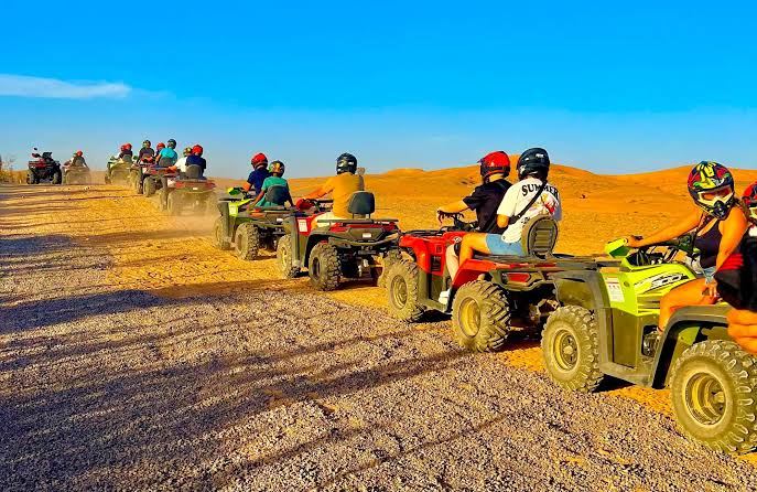 Mixed group of quad bikes lined up at sunset