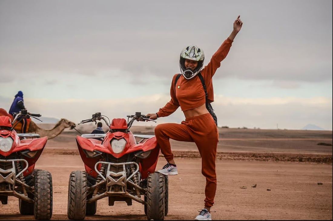 Woman quad biking in Agafay at sunset with golden light over the desert